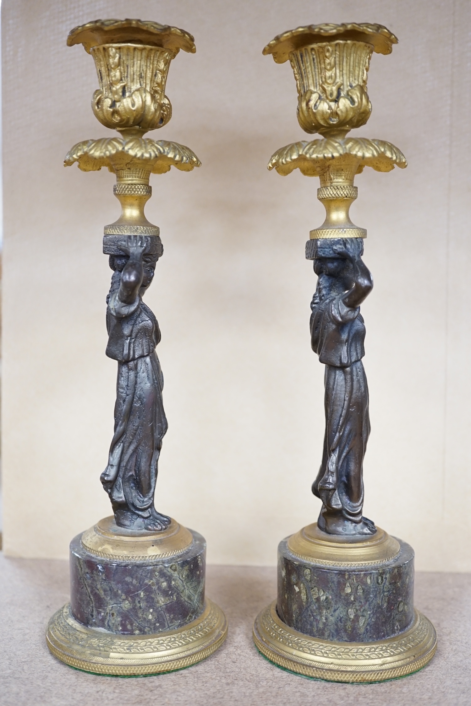 A pair of Regency style bronze and ormolu figural candlesticks on serpentine plinths, 22.5cm. Condition - fair to good